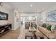 Open-concept living room featuring modern decor, sleek hardwood floors, and a seamless flow into the kitchen at 7232 Hodges Meadow Ln, Charlotte, NC 28213
