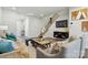 Cozy living room featuring modern decor, sleek hardwood floors, and an open staircase leading to the upper level at 7232 Hodges Meadow Ln, Charlotte, NC 28213