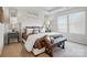 Elegantly styled main bedroom with neutral tones, upholstered headboard, and a cozy bench at 7232 Hodges Meadow Ln, Charlotte, NC 28213