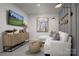 Finished basement recreation room features a comfortable sectional sofa and large TV at 7232 Hodges Meadow Ln, Charlotte, NC 28213