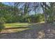 Lush backyard features mature trees, a well-maintained lawn, and a fenced perimeter at 738 Brockbank Rd, Charlotte, NC 28209