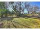 Large backyard with established trees and greenery creates a private outdoor space at 738 Brockbank Rd, Charlotte, NC 28209