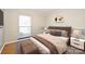 Comfortable bedroom featuring hardwood floors, a large window, and stylish furnishings at 738 Brockbank Rd, Charlotte, NC 28209