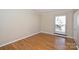 A sunlit bedroom is enhanced by hardwood floors, a neutral color scheme, and a well-placed window at 738 Brockbank Rd, Charlotte, NC 28209