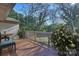 Outdoor deck with views of the well maintained lawn and surrounding trees at 738 Brockbank Rd, Charlotte, NC 28209