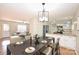 Inviting dining area showcasing hardwood floors, modern lighting, and seamless flow to the living room and kitchen at 738 Brockbank Rd, Charlotte, NC 28209