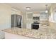 Modern kitchen showcasing stainless steel appliances, granite countertops, and white cabinetry at 738 Brockbank Rd, Charlotte, NC 28209