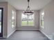 Bright dining room with chandelier and large windows offering natural light and neighborhood views at 8690 Crestwood Dr, Mount Pleasant, NC 28124