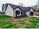 Angle view of home with brick and white siding, black trim, and well manicured yard at 8690 Crestwood Dr, Mount Pleasant, NC 28124
