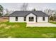 Back exterior of a home with white siding, black trim, and a concrete patio at 8690 Crestwood Dr, Mount Pleasant, NC 28124