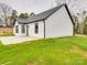 Exterior angle of a home with white siding, black trim, and a concrete patio at 8690 Crestwood Dr, Mount Pleasant, NC 28124