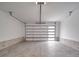 Spacious and clean garage with modern door featuring horizontal windows and brick accents on walls at 8690 Crestwood Dr, Mount Pleasant, NC 28124