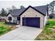 View of the modern garage with black accents and a concrete driveway at 8690 Crestwood Dr, Mount Pleasant, NC 28124