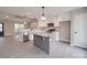 Open concept kitchen with white cabinets, stainless appliances, and a gray kitchen island at 8690 Crestwood Dr, Mount Pleasant, NC 28124