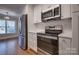 Modern kitchen with stainless steel appliances and white cabinetry at 9140 Providence Colony Dr, Charlotte, NC 28277