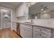 Kitchen features white cabinets, stainless steel appliances, and a view into the adjacent bathroom at 9140 Providence Colony Dr, Charlotte, NC 28277