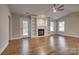 Living room with hardwood floors, fireplace, and built-in shelves at 9140 Providence Colony Dr, Charlotte, NC 28277