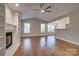 Spacious living area with hardwood floors, fireplace, and built-in shelving at 9140 Providence Colony Dr, Charlotte, NC 28277