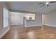 Living room features hardwood floors, ceiling fan, and kitchen views at 9140 Providence Colony Dr, Charlotte, NC 28277