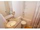 Main bathroom with a bathtub, granite vanity, and zig-zag shower curtain at 1028 Sharon Towns Dr, Charlotte, NC 28210