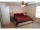Main bedroom with a king bed, ceiling fan and neutral decor at 1028 Sharon Towns Dr, Charlotte, NC 28210