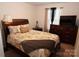 Bedroom with a double bed, dresser, and neutral decor at 1028 Sharon Towns Dr, Charlotte, NC 28210