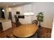 Kitchen and dining area with white cabinets, granite counters, and wood table at 1028 Sharon Towns Dr, Charlotte, NC 28210