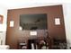 Living room with large TV, built-in shelving, and neutral wall colors at 1028 Sharon Towns Dr, Charlotte, NC 28210