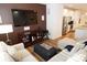 Open living room featuring comfortable seating, a large TV, and kitchen views at 1028 Sharon Towns Dr, Charlotte, NC 28210