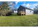 Backyard view showcasing a deck and lawn at 1077 Gibson St, Albemarle, NC 28001