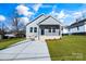 Gray house with a brick base, driveway, and landscaped lawn at 1077 Gibson St, Albemarle, NC 28001