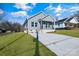 Gray house with a driveway and grassy yard at 1077 Gibson St, Albemarle, NC 28001
