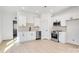 Modern white kitchen with stainless steel appliances and light wood floors at 1077 Gibson St, Albemarle, NC 28001