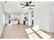 Open living room with light wood floors and ceiling fan at 1077 Gibson St, Albemarle, NC 28001