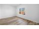 Simple bedroom with wood flooring and large window at 115 Brentwood Dr, Maiden, NC 28650