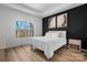 Bright bedroom with a king-size bed, large windows, and wood floors at 115 Brentwood Dr, Maiden, NC 28650