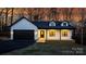 White house with black garage door and a landscaped yard at 115 Brentwood Dr, Maiden, NC 28650