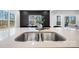 Modern kitchen features a farmhouse sink and quartz countertop at 115 Brentwood Dr, Maiden, NC 28650