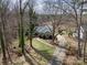 Aerial view of a well-manicured property with mature trees and a long driveway at 124 Muirfield Dr, Kings Mountain, NC 28086