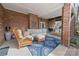 Relaxing back porch with brick, comfortable seating, and a porch swing at 124 Muirfield Dr, Kings Mountain, NC 28086