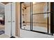 The renovated bathroom has a shower over tub, tile surround, and glass door at 124 Muirfield Dr, Kings Mountain, NC 28086