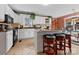 Cozy kitchen with white cabinets, a center island with stools, and rustic decor accents at 124 Muirfield Dr, Kings Mountain, NC 28086