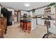 Spacious kitchen with white cabinets, tile flooring, a center island, and three bar stools at 124 Muirfield Dr, Kings Mountain, NC 28086