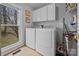 This is the laundry room, featuring white cabinets and a large window at 124 Muirfield Dr, Kings Mountain, NC 28086