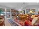 Elegant living room featuring a stone fireplace, leather furniture, and access to a sunroom at 124 Muirfield Dr, Kings Mountain, NC 28086