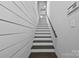 Staircase with white and dark wood steps and a handrail leading to upper level at 124 Muirfield Dr, Kings Mountain, NC 28086