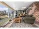 Bright and airy sunroom with large windows, comfortable seating, brick accents, and a view of the outdoors at 124 Muirfield Dr, Kings Mountain, NC 28086