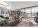 Bright sunroom with skylights and scenic views, furnished with a comfortable sofa and dining set at 124 Muirfield Dr, Kings Mountain, NC 28086
