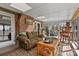 The sunroom features a brick accent wall and access to an outdoor deck at 124 Muirfield Dr, Kings Mountain, NC 28086