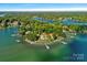 Island home with lush greenery and multiple docks at 132 Rollingwood Ln, Mooresville, NC 28117